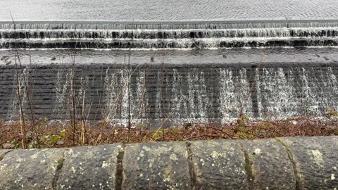 Water flowing down wide dam waste stepped weir or spillway. Stock-Footage 331423729