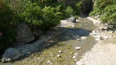 Water flowing downwards over cliffs and rocks. Raganello Gorges Stock Footage 139923510