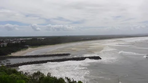 Water flowing from Evans river to two break walls out to the ocean Stock Footage 269372170