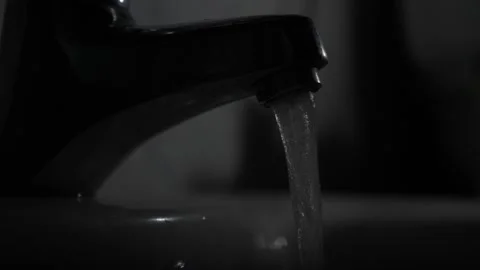 Water Flowing from Faucet in Dark Setting Stock Footage 285058524