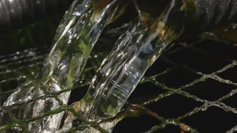 Water flowing into a garden pond from a filter stock footage Stock Footage 337464991