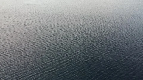 Water flowing gently on the surface of a lake during daytime hours Stock Footage 328191568