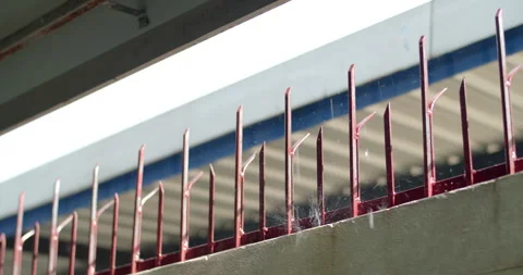 Water flowing gently from the tip of a spiked iron fence during a calm rain. Stock Footage 311596006