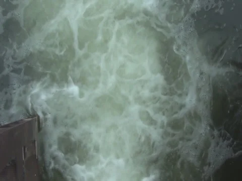 Water flowing from the open sluice gates of dam. Stock Footage 78060192