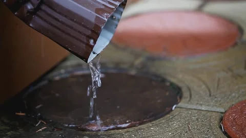 Water flowing out of the drainpipe. The concept of rain, autumn, bad weather Stock Footage 153867353