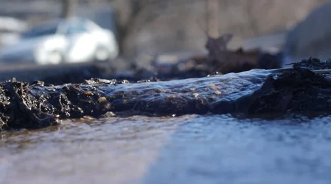 Water flowing over asphalt in gutter Stock Footage 47749070