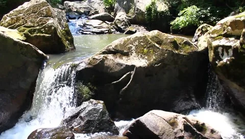 Water flowing over bolders Stock Footage 6217795