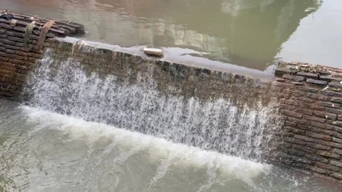 Water flowing over a brick wall Stock Footage 324752371
