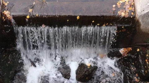 Water flowing over concrete dam construction Stock Footage 117576653