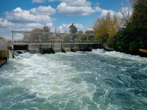 Water Flowing Over a Concrete Weir with fish ladder on the river Thames Stock Photos