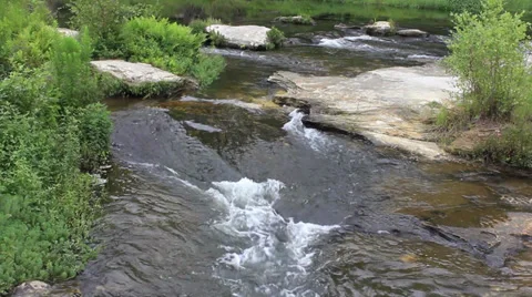 Water flowing over large rocks in river Video stock 27338998