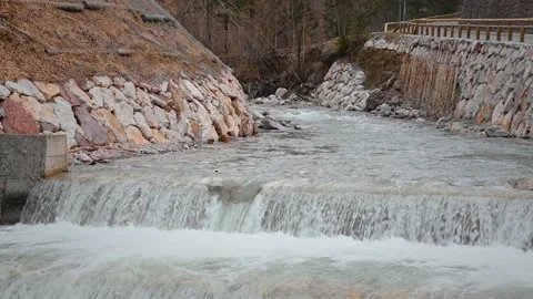 Water flowing over man made cascades in Alps mountains Stock Footage 150444516