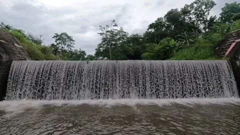 Water Flowing Over Man-Made Spillway – Large River Canal, Indonesia Video stock 321103573