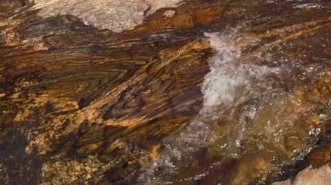 Water Flowing Over Naturally Textured Stone Stock Footage 12815533