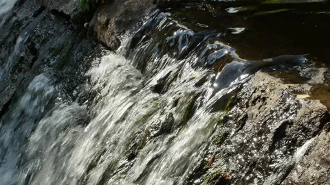 Water flowing over an old stone dam construction Stock-Footage 206288563