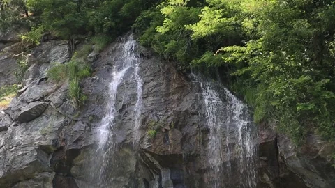 Water flowing over rocks in the forest Видео 310156579