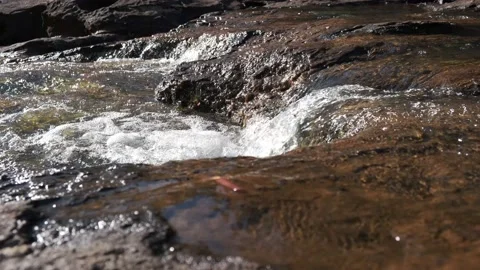 Water Flowing Over Rocks, Low Angle, 4K Stock Footage 134371373