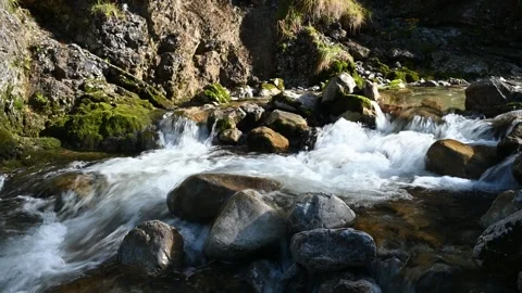 Water flowing over rocks of a mountain stream in autumn 스톡 동영상 260828832