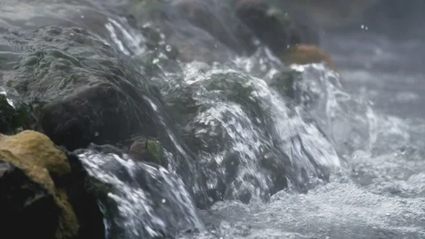 Water flowing over rocks in a river Stock Footage 113236355