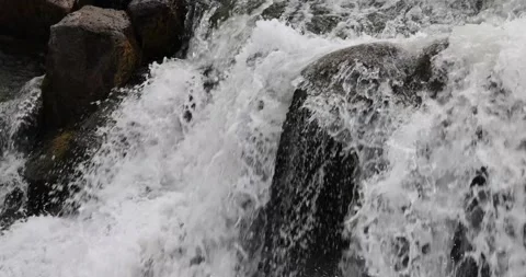 Water flowing over rocks on a river 스톡 동영상 247228342