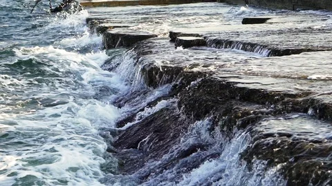 Water flowing over the rocky surface and waves are making white foam. Stock Footage 111416729