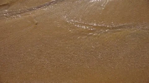 Water flowing over sand on beach. Видео 22322563