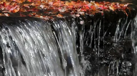 Water flowing over small dam Stock Footage 47559989