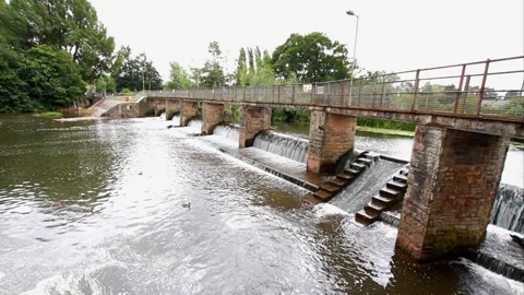 Water flowing over a weir bridge Stock Footage 296772170
