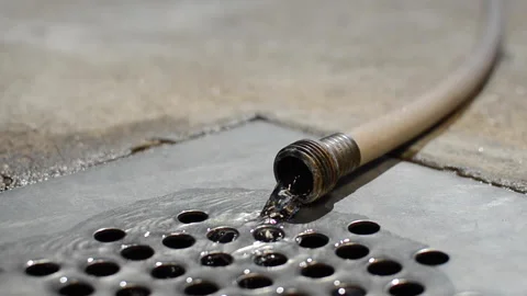 Water flowing from the pipe into the drain Stock Footage 140623177