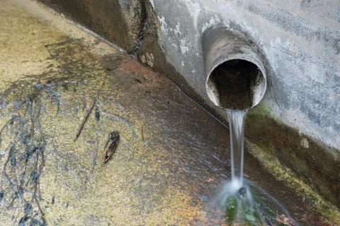 Water Flowing From Pipe Environment Stock Photos
