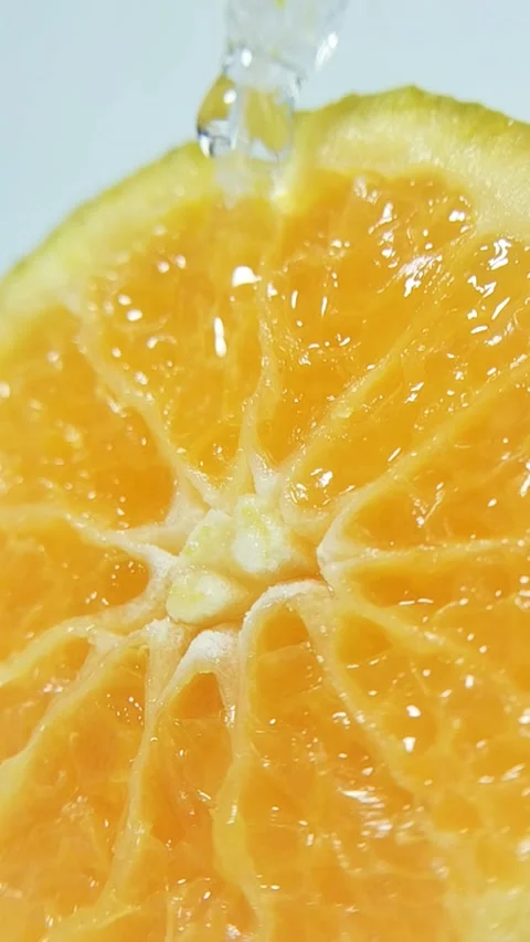 Water flowing from a pipette tip through fresh orange fruit fibers. Close-u.. Stock Footage 330749540