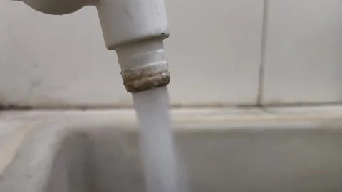 Water flowing from plastic tap close-up stock footage Stock Footage 345427861