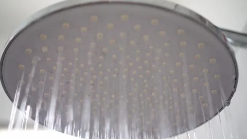 Water flowing from rain shower head in bathroom. Stock Footage 342634686