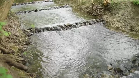 Water flowing into the river Stock Footage 130198393