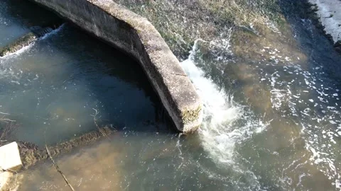 Water flowing into the river Stock Footage 131010779