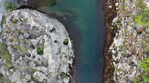 Water flowing into the river. Stream bed cut deep into rock Stock Footage 133161435