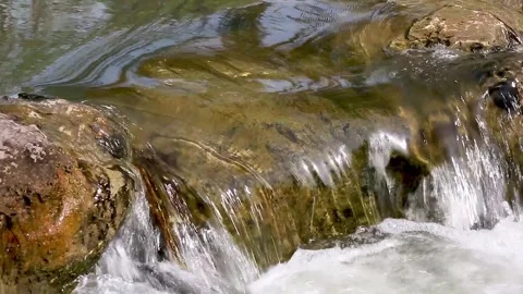 Water flowing on rocks into a pool Video stock 138562504