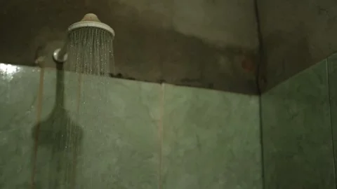 Water flowing from a showerhead in a rustic bathroom, Xinguara, Pará Stock Footage 317793799