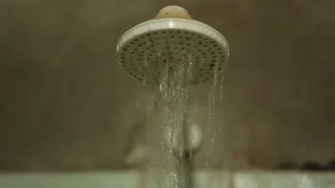 Water flowing from a showerhead in a rustic bathroom, Xinguara, Pará Stock Footage 317793844