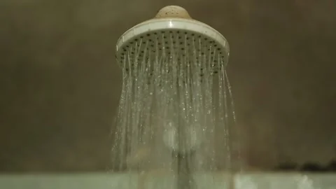 Water flowing from a showerhead in a rustic bathroom, Xinguara, Pará Stock Footage 317793865