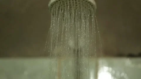 Water flowing from a showerhead in a rustic bathroom, Xinguara, Pará Stock Footage 317793916