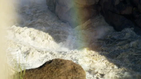 Water flowing in slow motion with rainbow over it Stock Footage 234907657