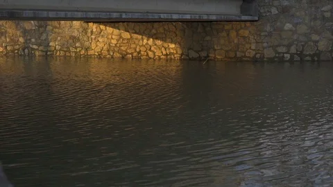 A water flowing in the small river under the bridge Stock-Footage 91066320