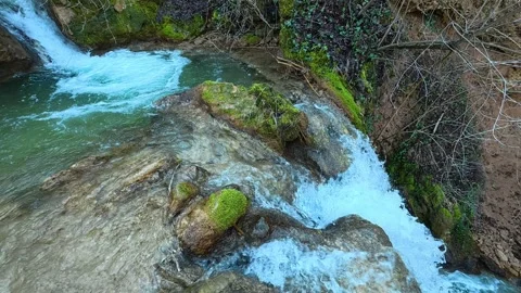 Water Flowing into small waterfall Stock Footage 330552067