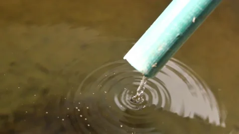 Water flowing through green pipe Stock Footage 147974933