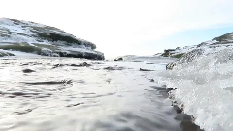 Water flowing through river with ice and snow Stock Footage 83938822