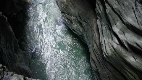 Water flowing through the rocks handheld shot Stock Footage 166646092