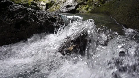 Water flowing through rocks in slow motion Stock Footage 107577987
