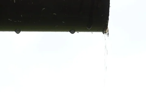 Water flowing through a trough under the roof during a torrential rain Stock Footage 76426235