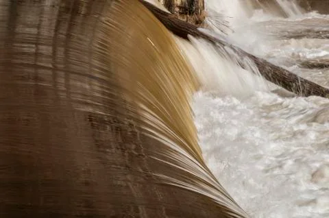 Water flowing off tree trunk jammed in Blackstone River Stock Photos